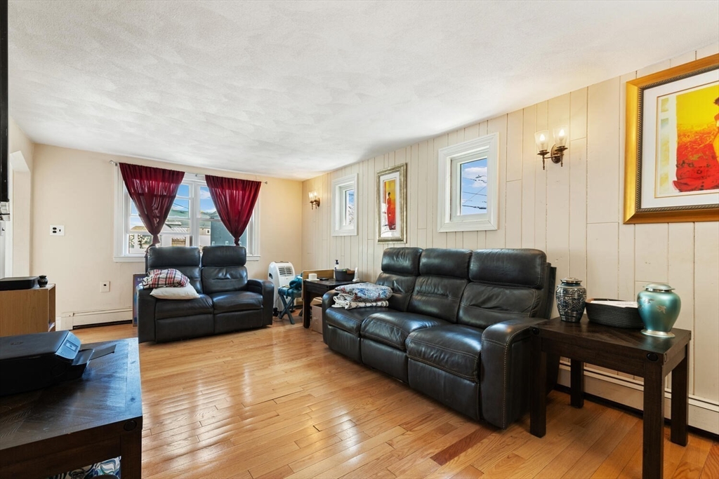 152 Springvale Avenue Everett, MA 02149 - Photo 5 of 30 a living room with furniture and a wooden floor