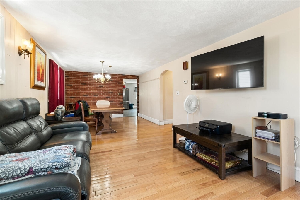 152 Springvale Avenue Everett, MA 02149 - Photo 8 of 30 a living room with furniture and a flat screen tv