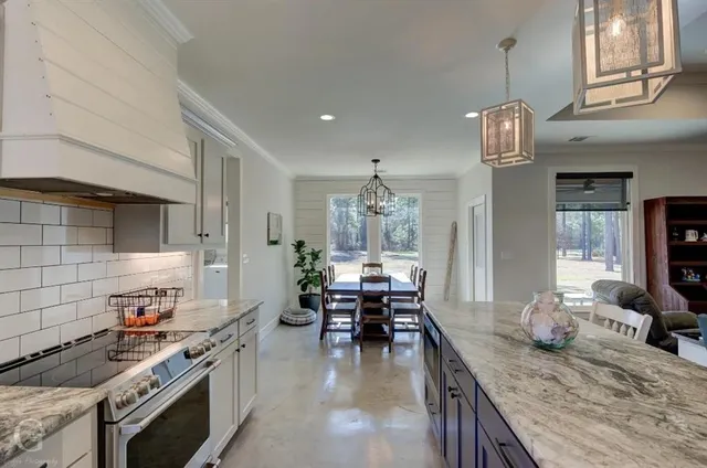a kitchen with sink stove and cabinets