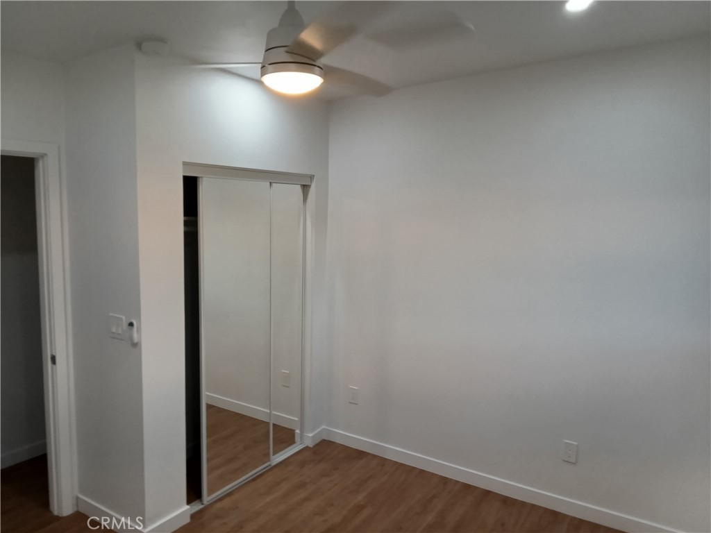 66954 Appian Way Joshua Tree, CA 92252 - Photo 23 of 26 an empty room with wooden floor closet and windows