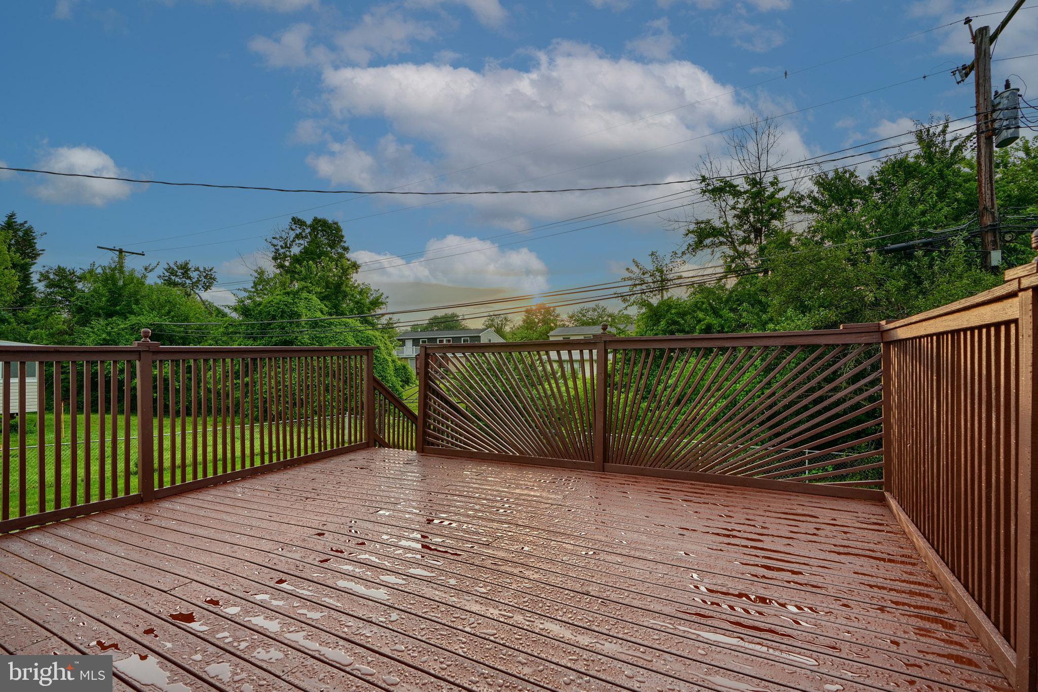 3410 Ripple Road Windsor Mill, MD 21244 - Photo 54 of 61 a view of deck with wooden floor and fence next to a yard