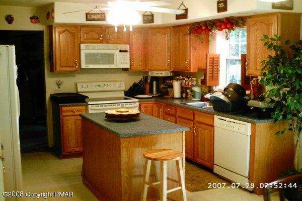2701 Devon Road Tobyhanna, PA 18466 - Photo 7 of 10 a kitchen with stainless steel appliances granite countertop a sink stove and cabinets