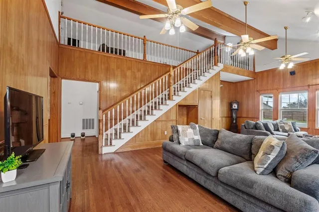 a living room with furniture or wooden floor and a chandelier