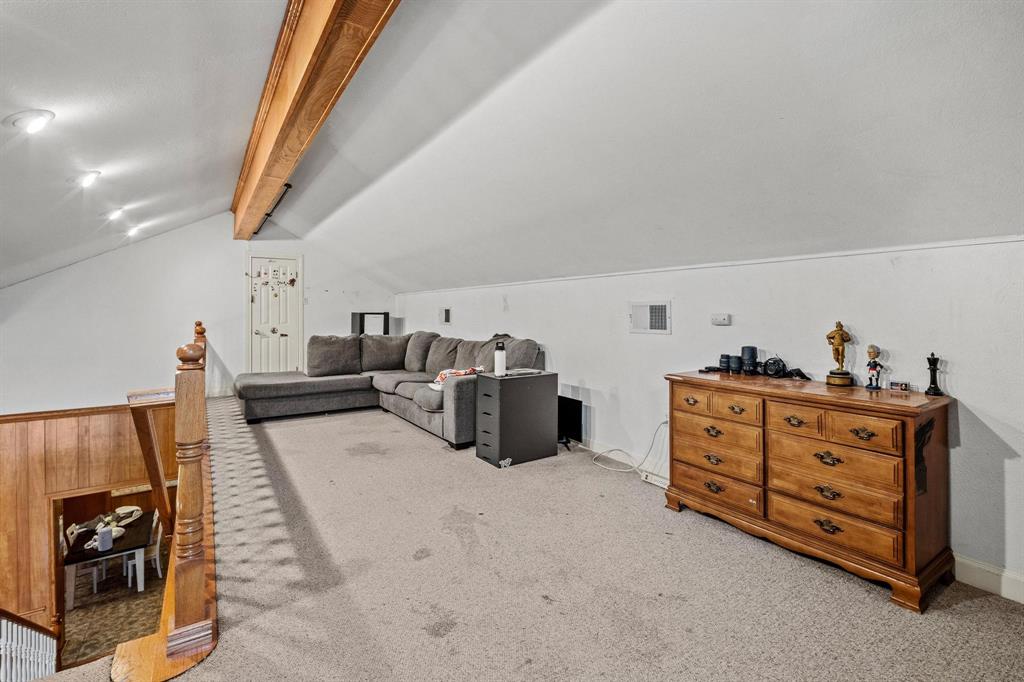 715 East 5th Street Ferris, TX 75125 - Photo 12 of 40 a bed room with a bed and a couch