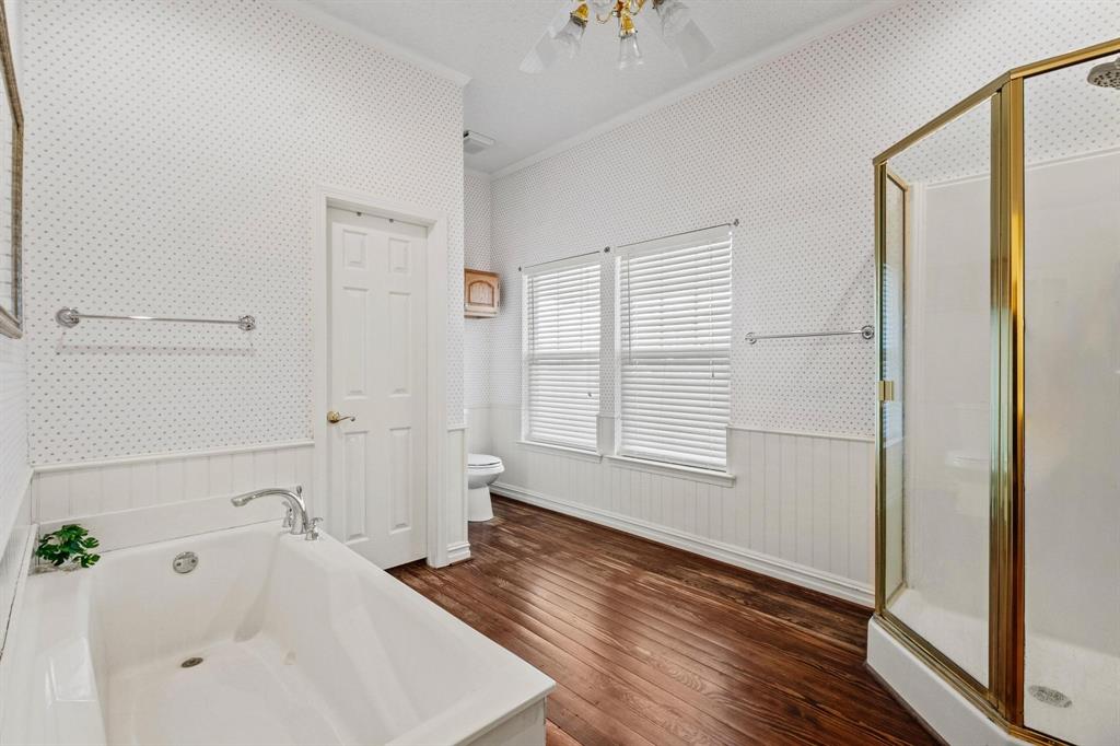 715 East 5th Street Ferris, TX 75125 - Photo 21 of 40 a bathroom with a bathtub and a window