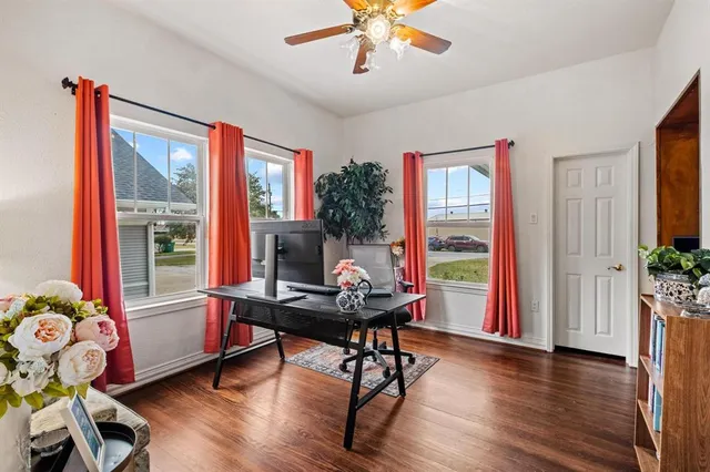 a workspace with furniture window and wooden floor