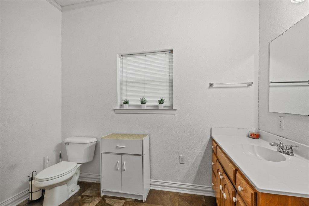 715 East 5th Street Ferris, TX 75125 - Photo 24 of 40 a bathroom with a sink toilet and vanity