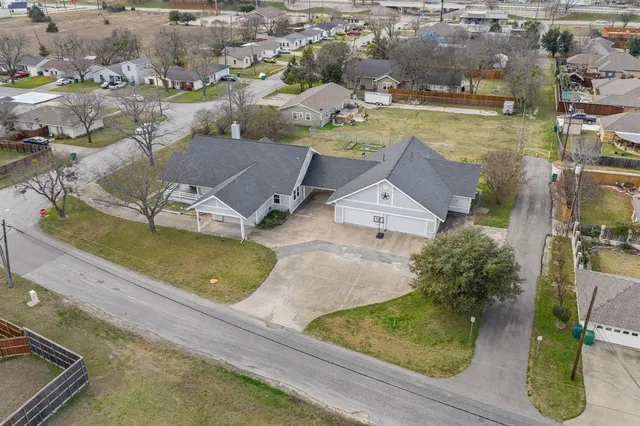 an aerial view of residential houses with outdoor space