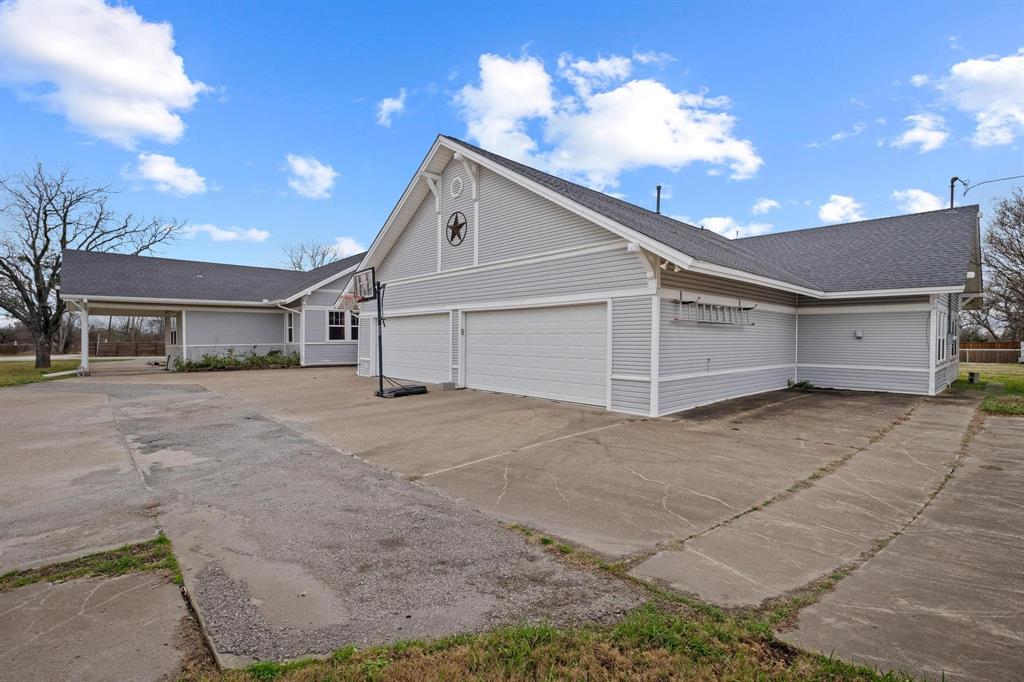 715 East 5th Street Ferris, TX 75125 - Photo 36 of 40 a view of a house with a yard and garage