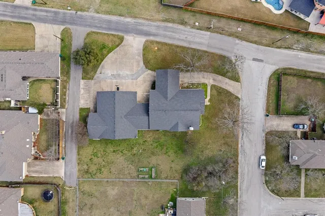 an aerial view of a house with a swimming pool
