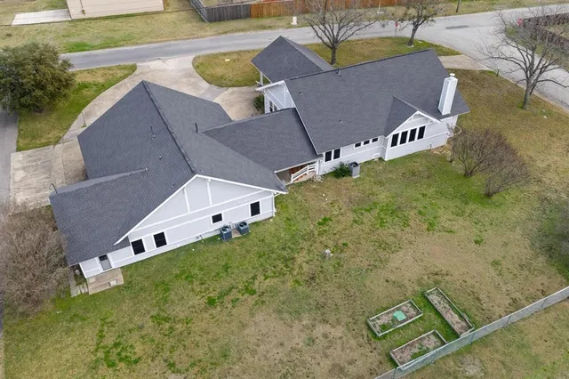a aerial view of a house with pool