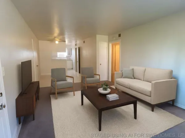 a view of a small space with wooden floor and a ceiling fan