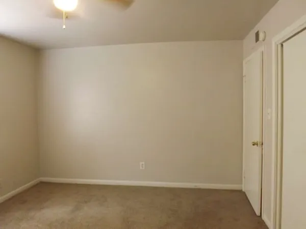 a view of a hallway with a chandelier fan
