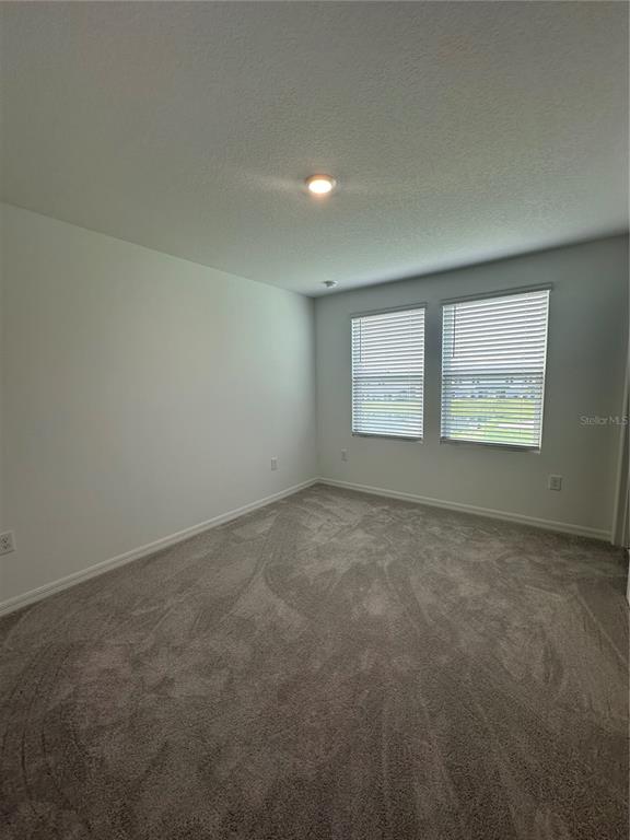 3137 Skyline Loop Kissimmee, FL 34758 - Photo 14 of 14 an empty room with a window