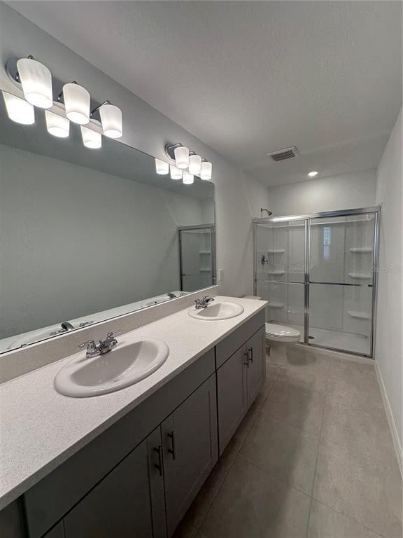 3137 Skyline Loop Kissimmee, FL 34758 - Photo 4 of 14 a bathroom with a sink double vanity granite and a mirror