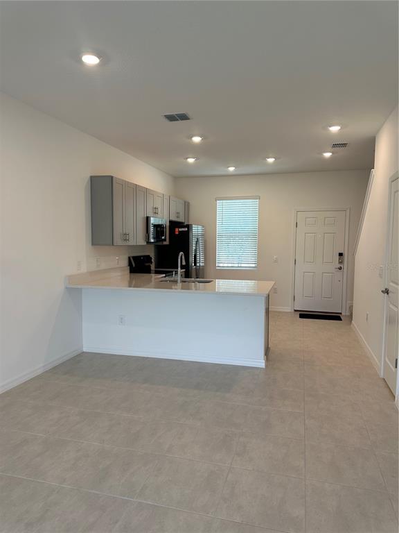 3137 Skyline Loop Kissimmee, FL 34758 - Photo 6 of 14 an open kitchen with refrigerator and microwave