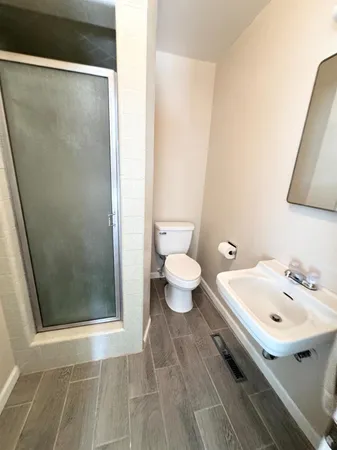 a kitchen with a sink and wooden floor