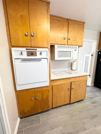 a kitchen with a refrigerator and cabinets