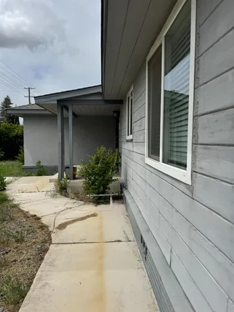 a view of a house with a backyard