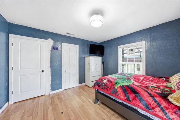 a bedroom with a bed and a window