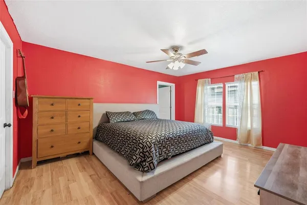 a bed sitting in a bedroom next to a window