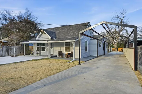 a front view of a house with a yard outdoor seating and garage