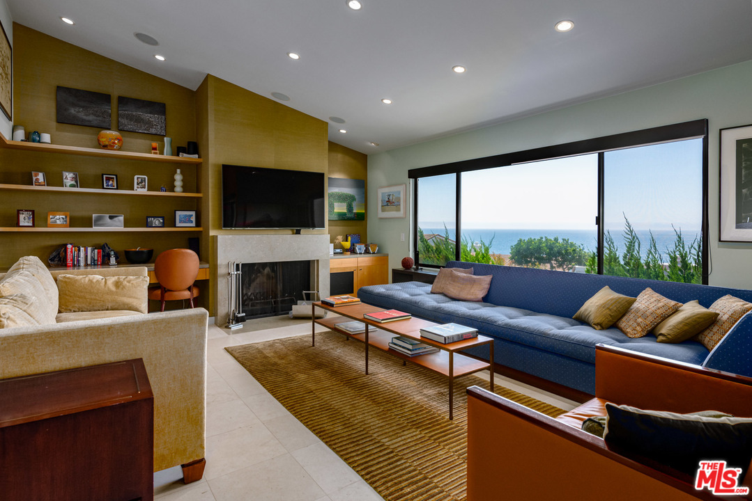 6789 Shearwater Lane Malibu, CA 90265 - Photo 1 of 21 a living room with fireplace furniture and a flat screen tv