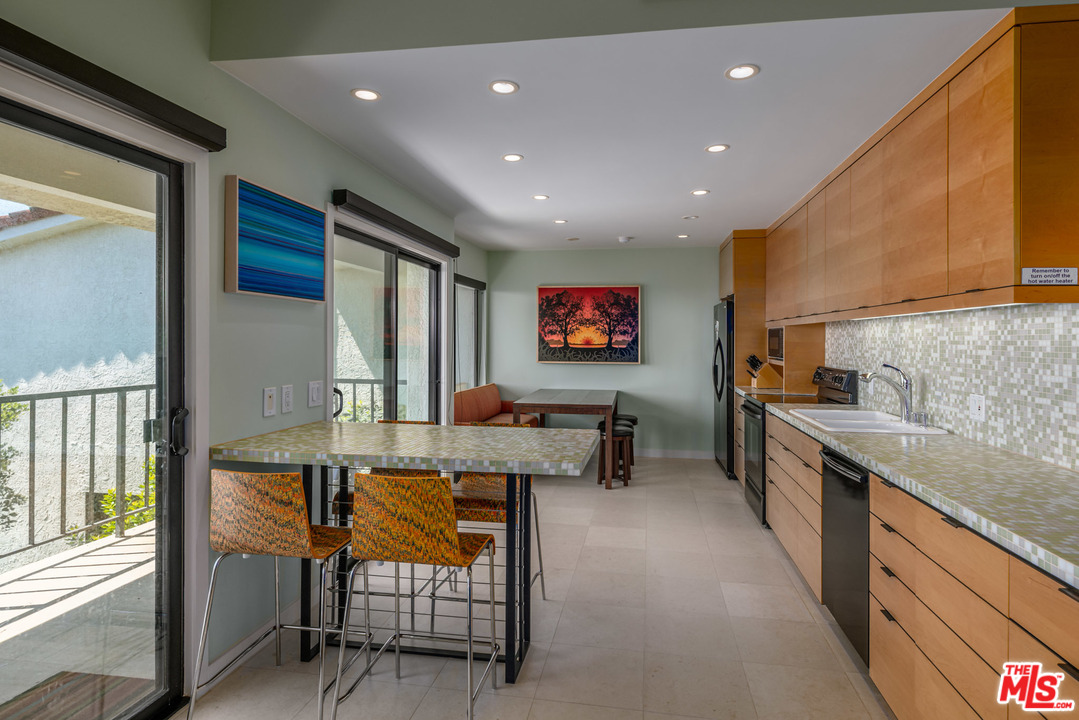 6789 Shearwater Lane Malibu, CA 90265 - Photo 3 of 21 a living room with furniture a flat screen tv and a large window