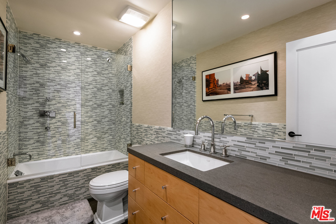6789 Shearwater Lane Malibu, CA 90265 - Photo 7 of 21 a bathroom with a granite countertop sink toilet and shower