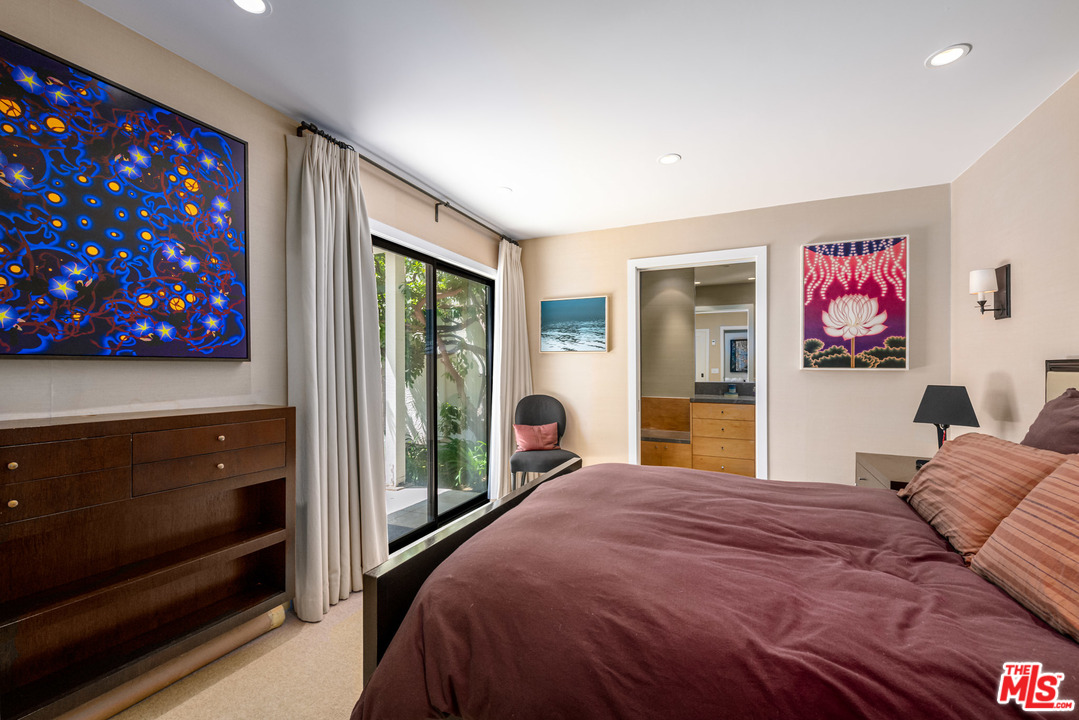 6789 Shearwater Lane Malibu, CA 90265 - Photo 8 of 21 a bedroom with a bed and a dresser next to a window