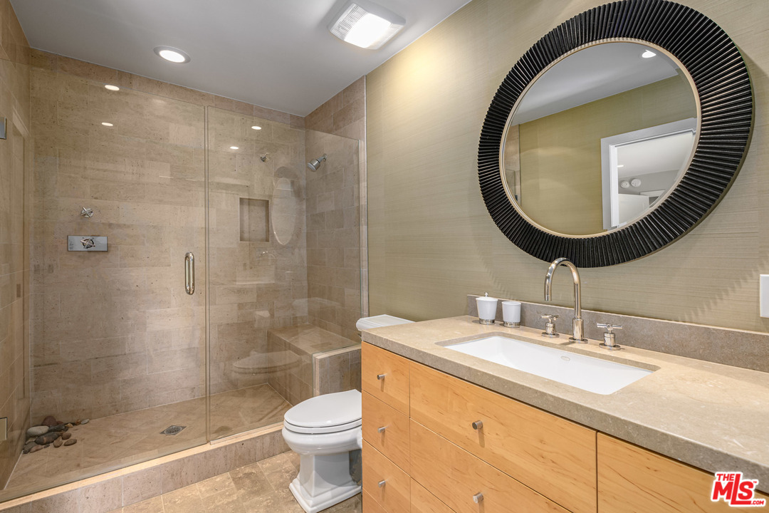 6789 Shearwater Lane Malibu, CA 90265 - Photo 9 of 21 a bathroom with a sink a toilet and a mirror