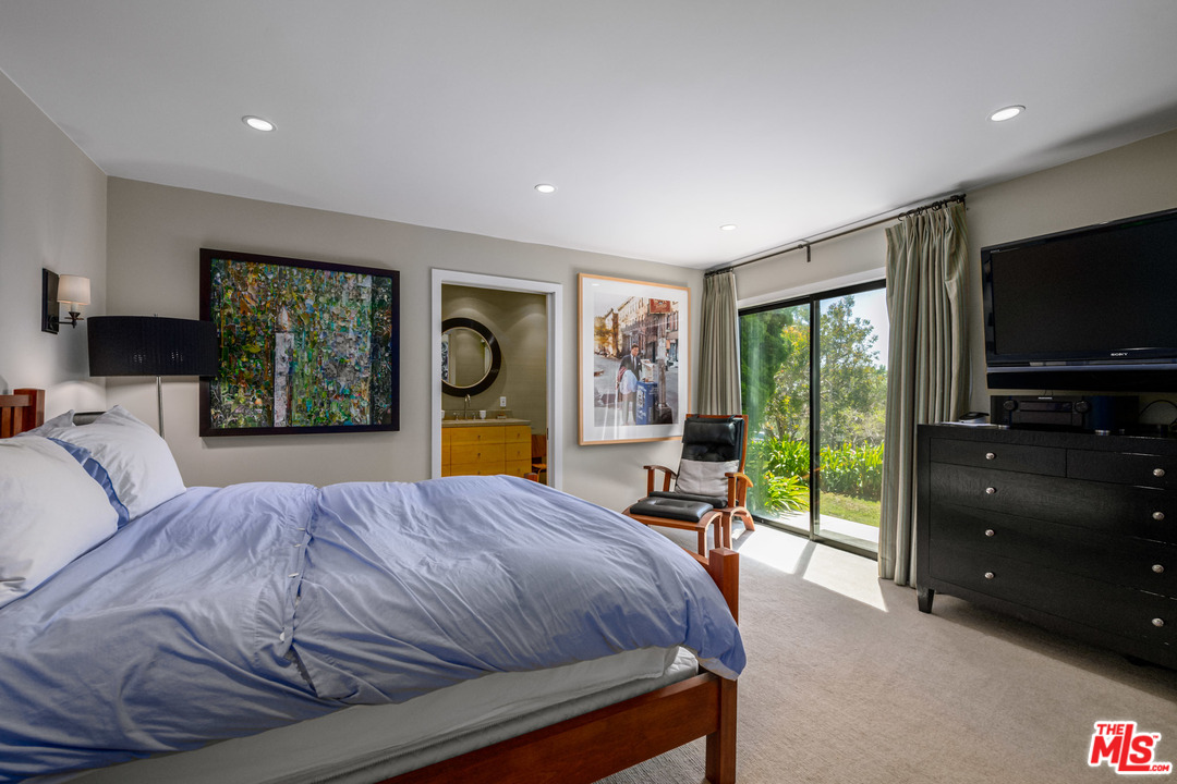 6789 Shearwater Lane Malibu, CA 90265 - Photo 10 of 21 a bedroom with a bed and large windows