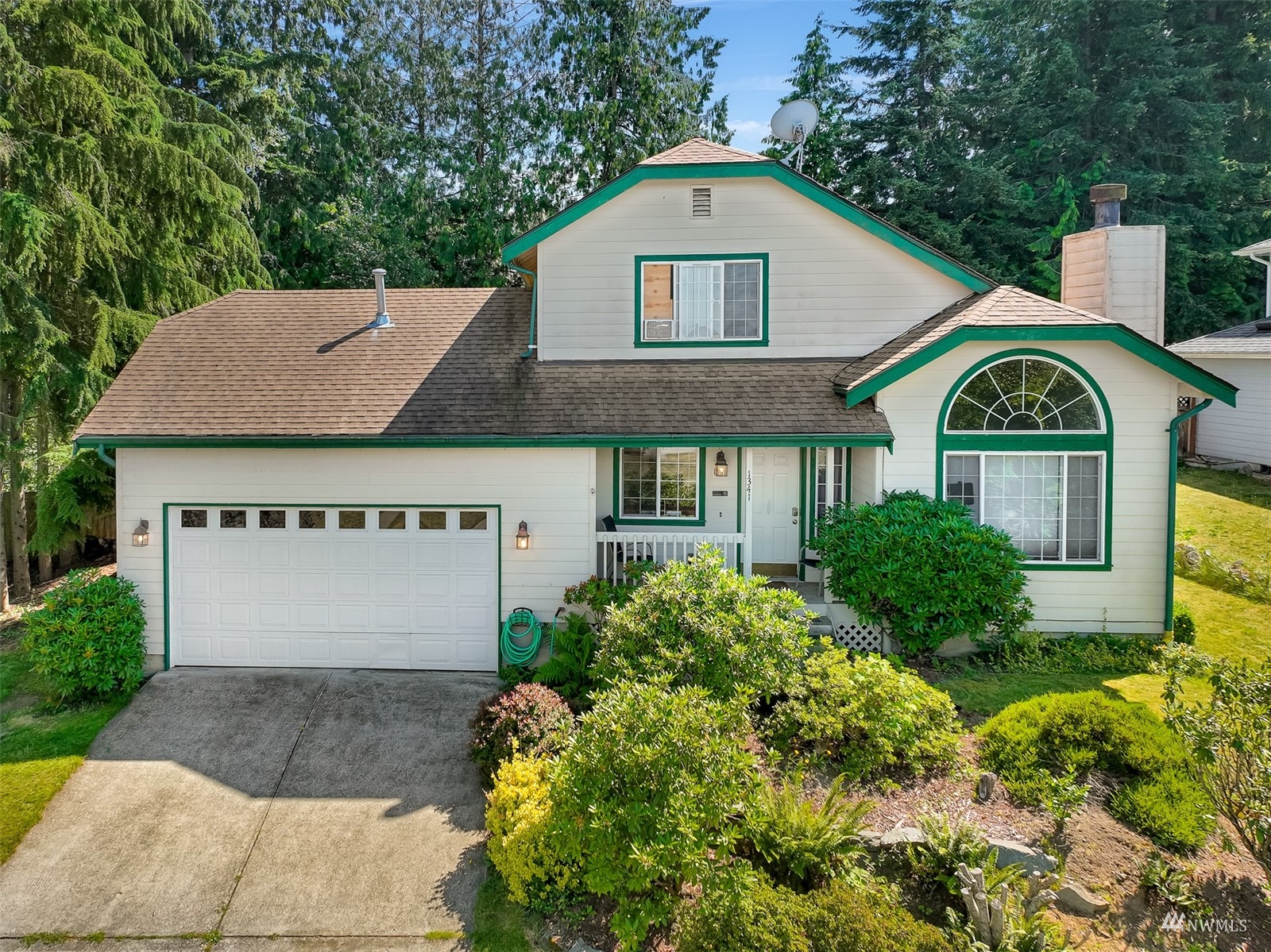 1341 Roma Road Bellingham, WA 98226 - Photo 1 of 40 a front view of a house with a yard and garage