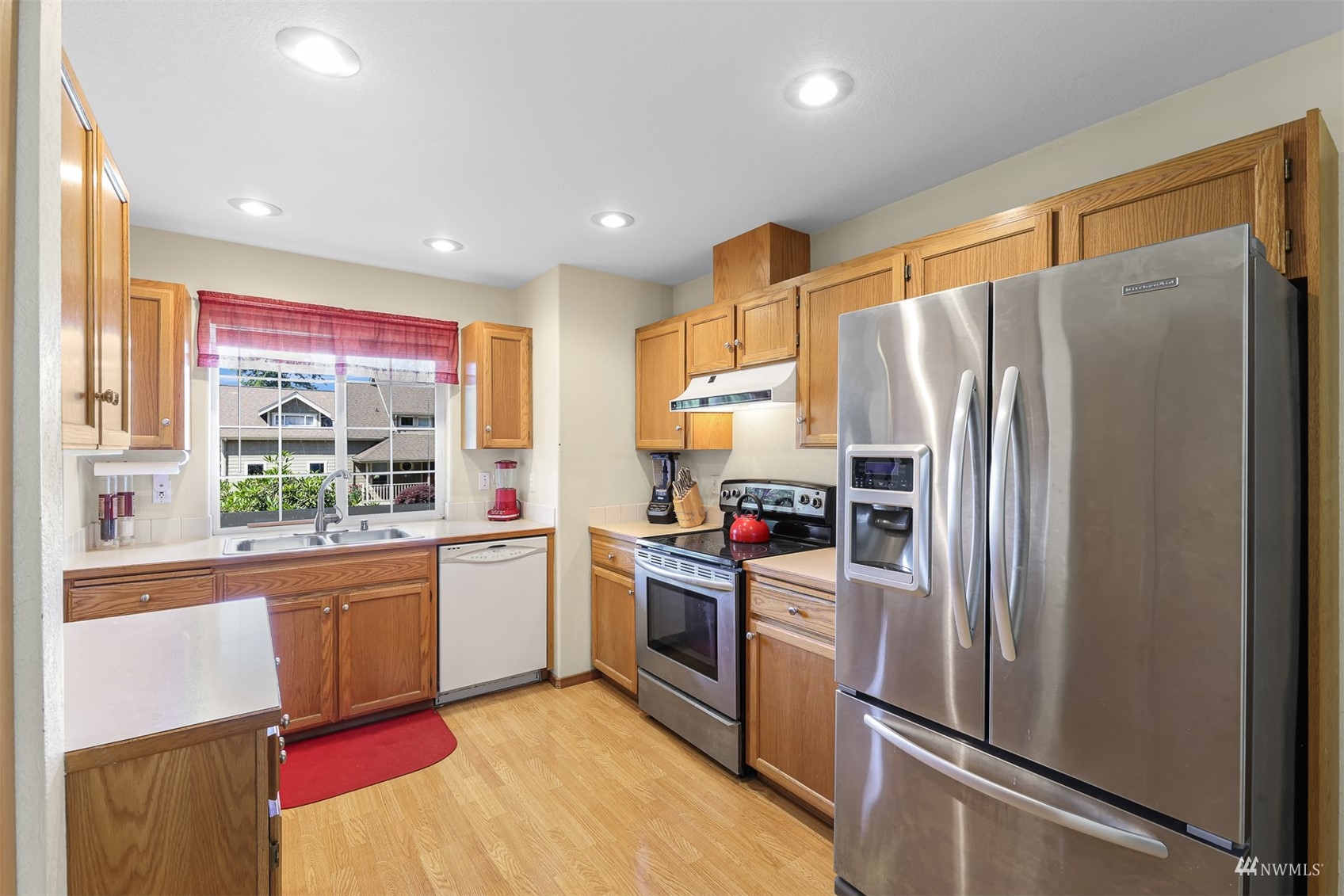 1341 Roma Road Bellingham, WA 98226 - Photo 24 of 40 a kitchen with stainless steel appliances granite countertop a refrigerator and a stove top oven
