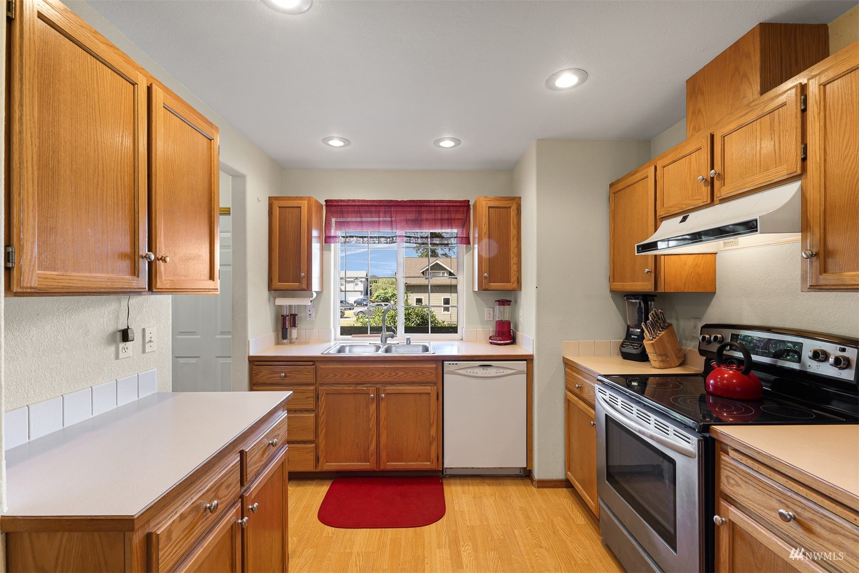 1341 Roma Road Bellingham, WA 98226 - Photo 25 of 40 a kitchen with a sink stove and cabinets
