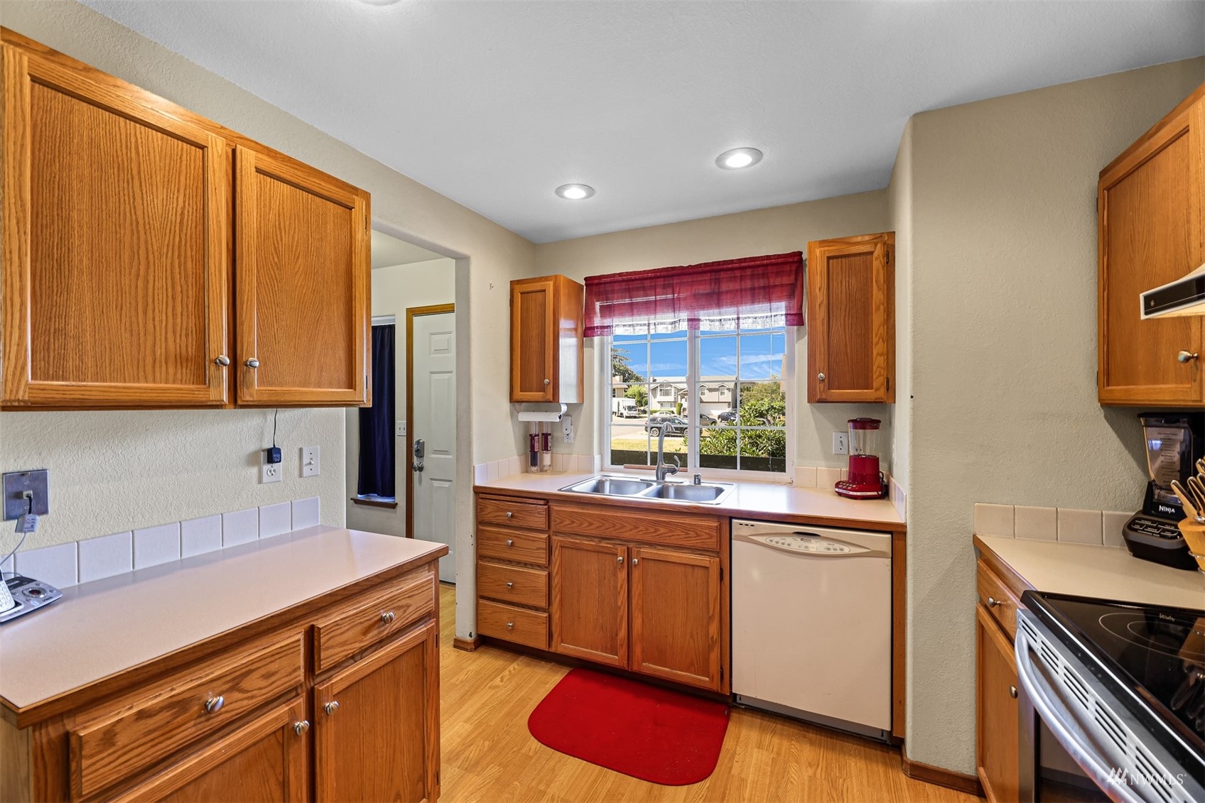 1341 Roma Road Bellingham, WA 98226 - Photo 26 of 40 a kitchen with a sink stove and cabinets