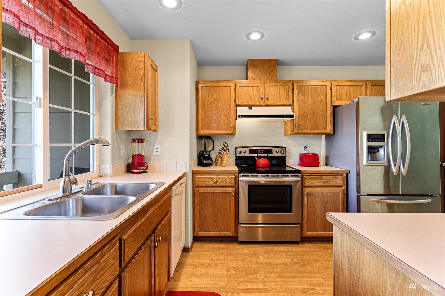 1341 Roma Road Bellingham, WA 98226 - Photo 28 of 40 a kitchen with stainless steel appliances a sink cabinets and a refrigerator