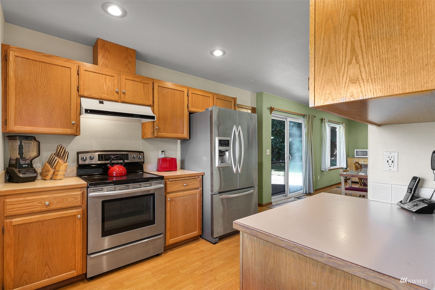 1341 Roma Road Bellingham, WA 98226 - Photo 29 of 40 a kitchen with stainless steel appliances a stove refrigerator sink and cabinets