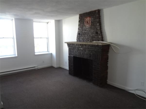 an empty room with a fireplace
