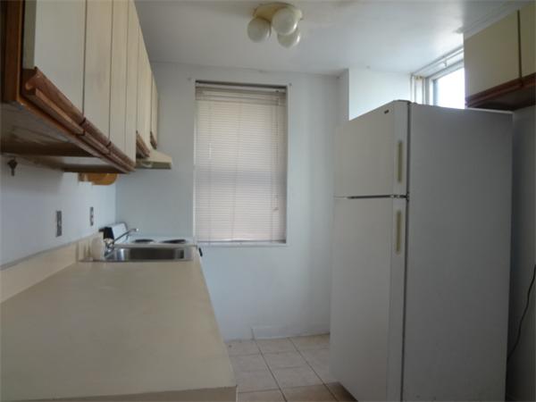 88 Brooks Street, Unit 2 Boston, MA 02128 - Photo 2 of 6 a kitchen with a refrigerator and cabinets