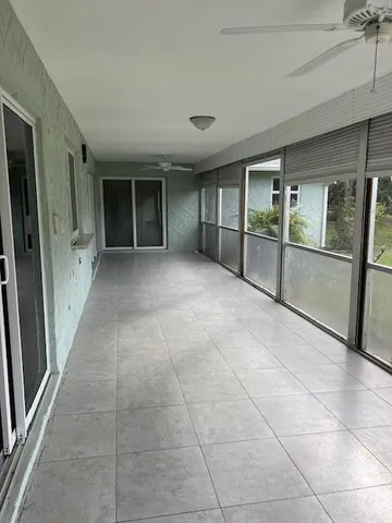 a view of an empty room with a fireplace and a window