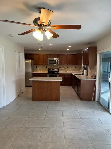 a kitchen with stainless steel appliances granite countertop a sink counter top space cabinets and stainless steel appliances