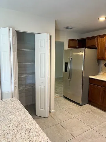 a bathroom with a refrigerator and a sink