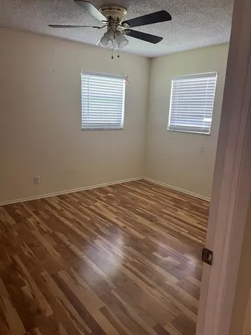 a view of a room that has a bed and a window