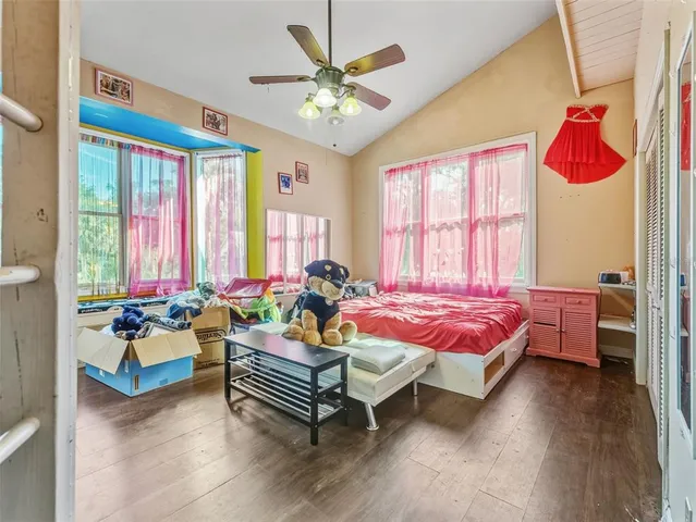 a living room with furniture a window and wooden floor