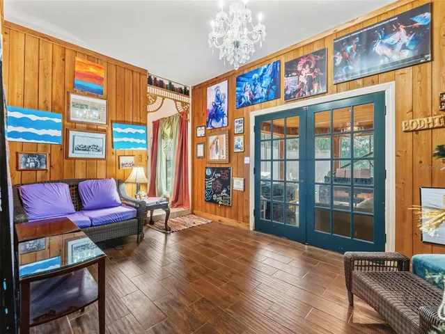 a room with furniture a large window and a chandelier