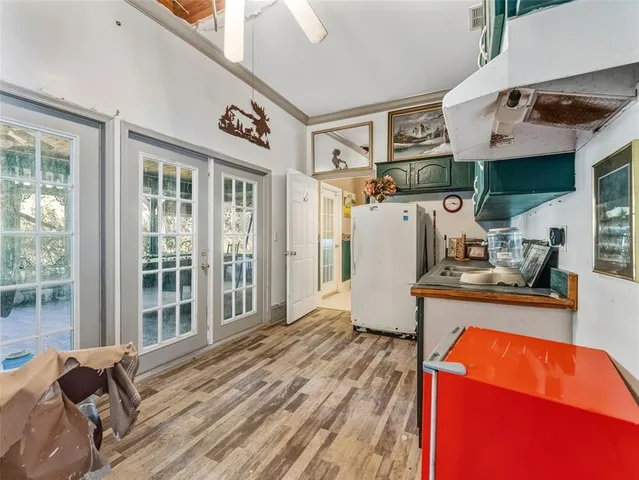 a room with pool table and glass windows