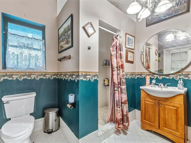 a room with stainless steel appliances kitchen island granite countertop a stove and a sink