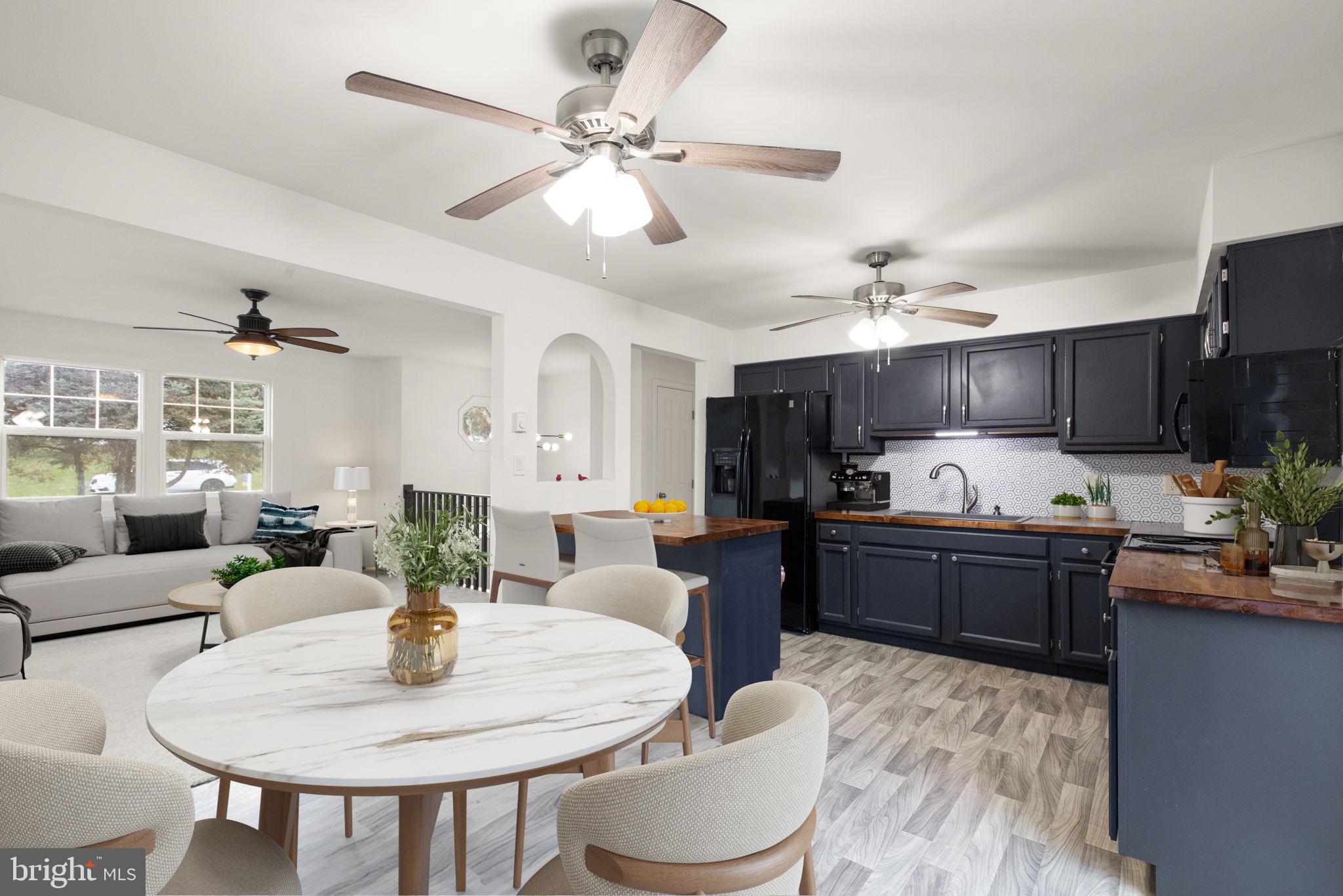 148 Sharon Street Rising Sun, MD 21911 - Photo 11 of 43 a kitchen with a dining table and chairs