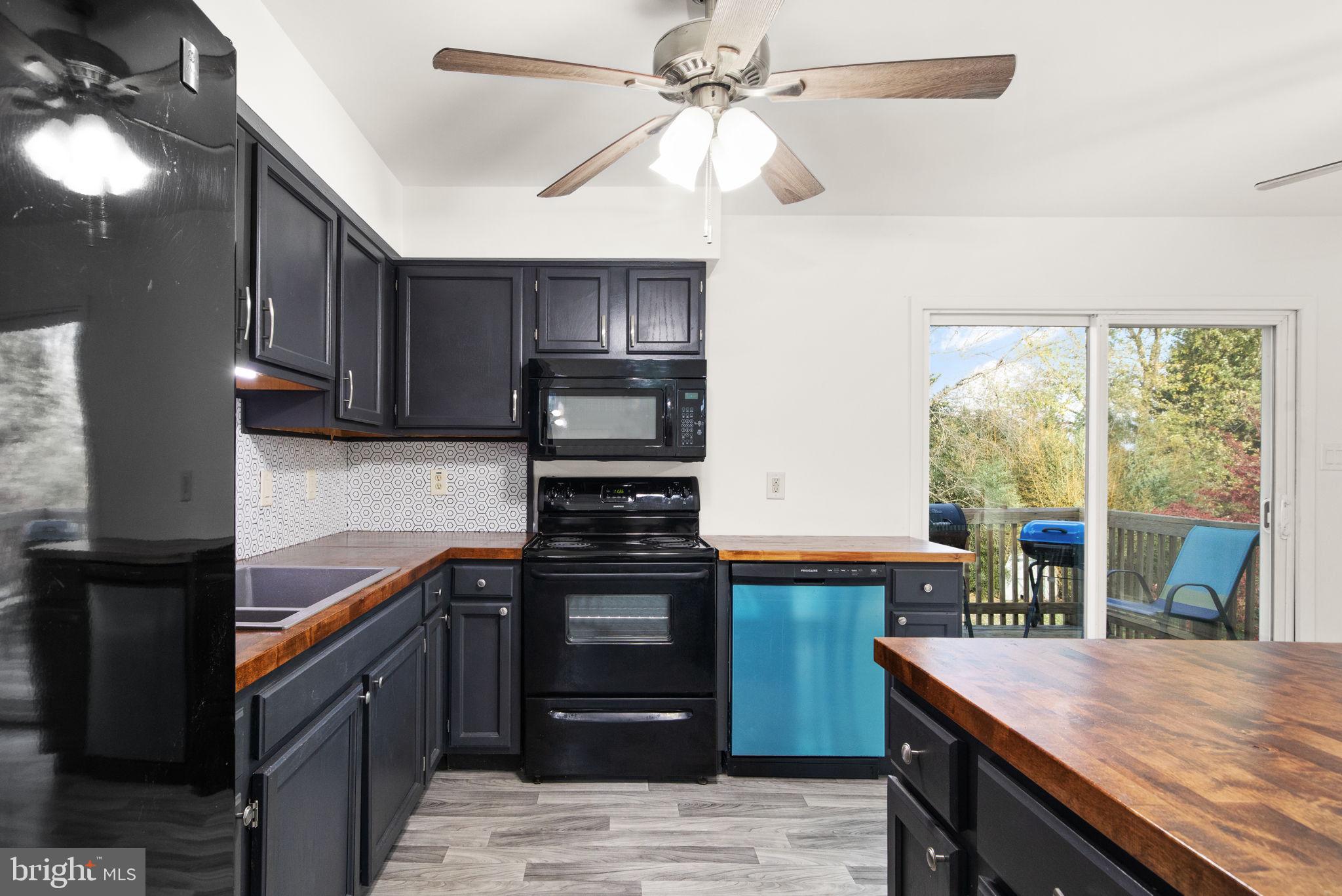 148 Sharon Street Rising Sun, MD 21911 - Photo 13 of 43 a kitchen with stainless steel appliances granite countertop a stove and a refrigerator